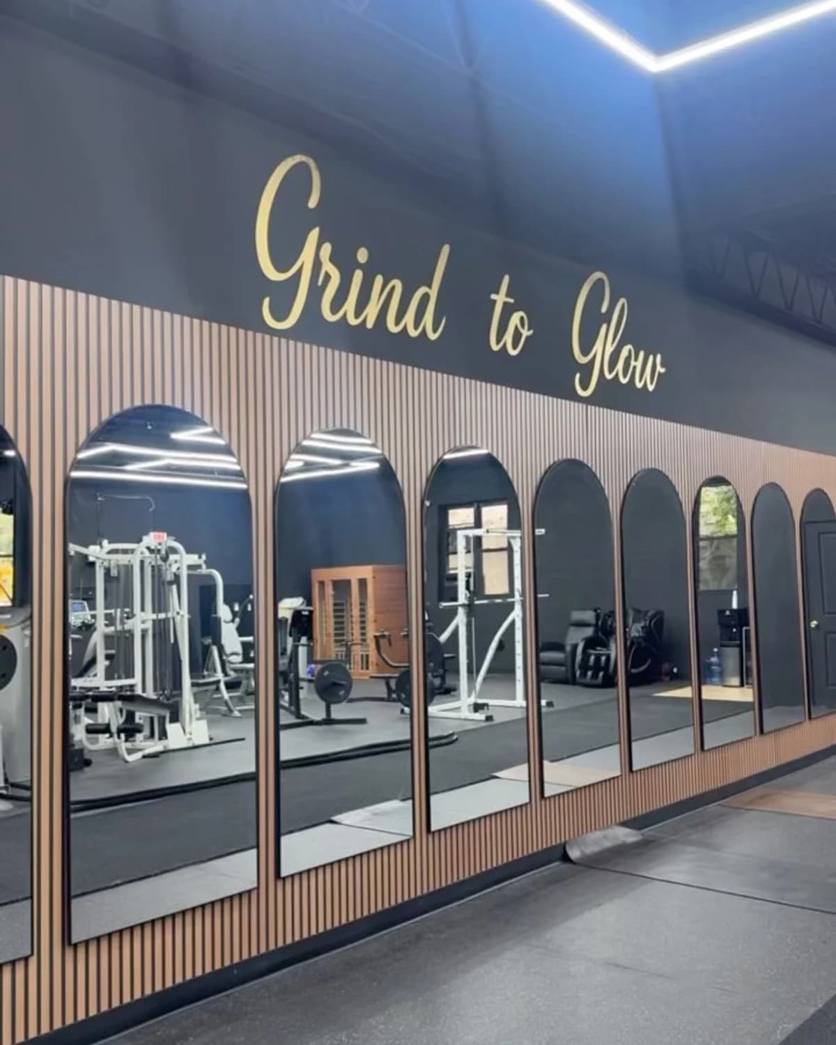 The Grind to Glow signature wall and mirrored training floor